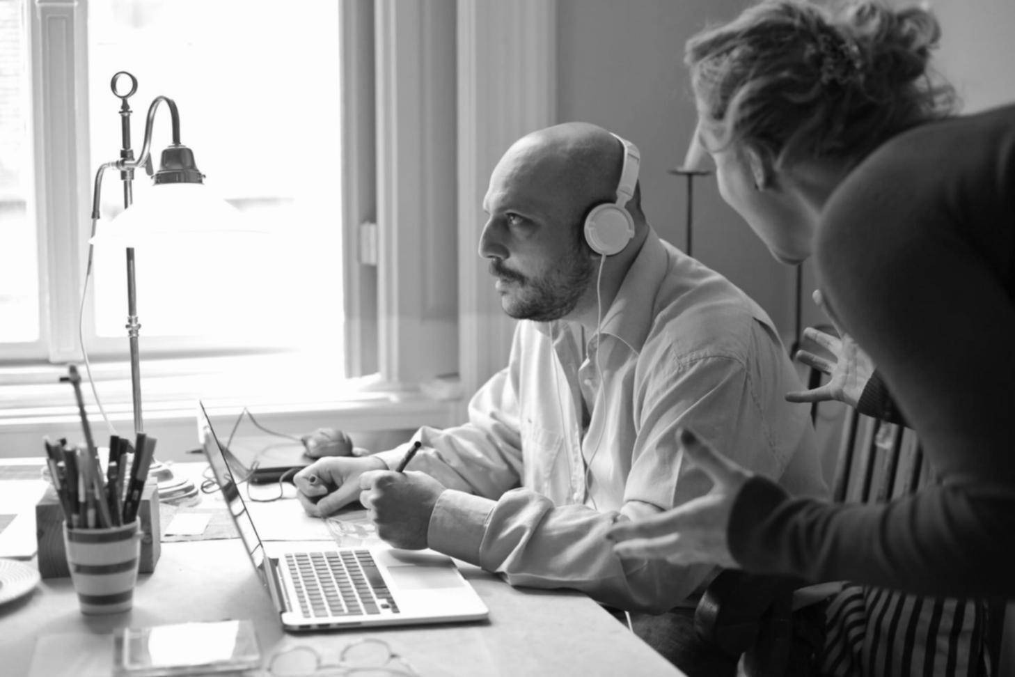Business owner reviewing financial statements and ratio calculations at desk